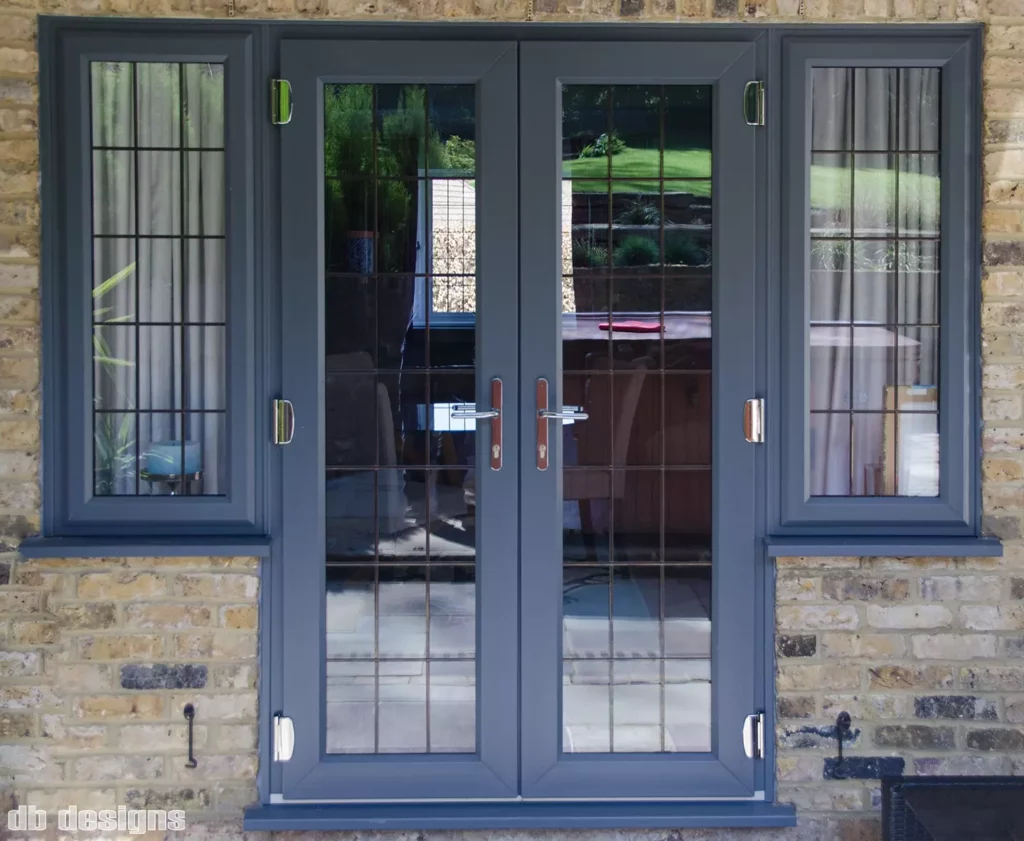 uPVC French doors at rear of house with chrome hardware and leaded Georgian bars