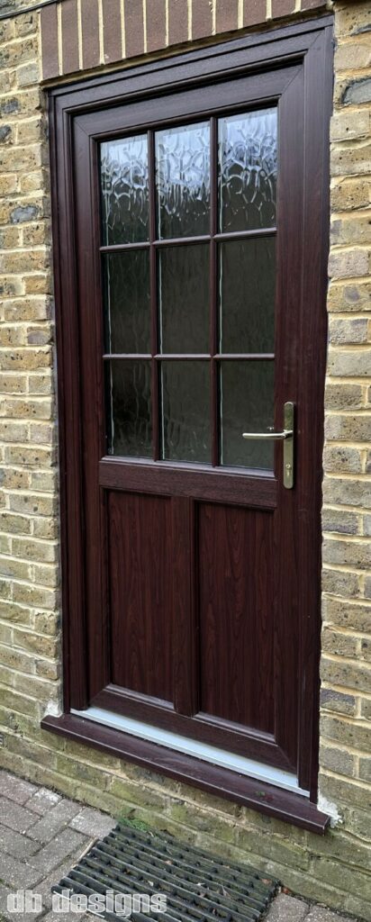 Composite back door with woodgrain effect, brass door handle
